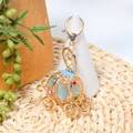 Close-up of golden pumpkin carriage keychain with opal stones and rhinestone details - Light Blue Gemstone Style (Color 2)