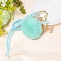 Detail of mint green pompom keychain with heart clip, braided rope and rhinestone H charm - Letter H / Mint Green