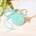 Detail of mint green pom-pom keychain with rhinestone butterfly and heart clasp - Letter X