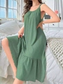 Close-up of grass green dress featuring vertical texture and tiered ruffle hem detail - Dark Green