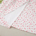 Close-up of white ribbed knit fabric with pink floral prints and side slit detail - S / Pink Floral