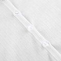 Close-up of white knitted jacquard fabric with delicate hollow patterns and clear buttons - S / White