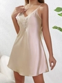 Detail of champagne satin sleepwear featuring delicate white lace trim and V-neckline - Champagne