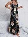 Detail of elegant black satin nightgown featuring large floral prints and thin straps - Black