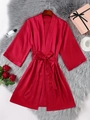 Detailed view of red satin silk robe with waist tie on luxury plush carpet background - S / Red