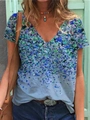 Detail of V-neck floral t-shirt with blue and green abstract print on light fabric - Blue