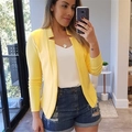 Detailed view of women's bright yellow casual blazer with minimalist open-front design - S / Yellow