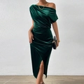 Detail of emerald green velvet dress showing asymmetric shoulder and pleated waist design - Dark Green
