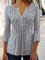 Close-up of women's gray V-neck blouse featuring white geometric prints and decorative buttons - S / Gray
