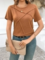 Detail of a brown short sleeve T-shirt featuring a cross-pleated design and golden necklace - S / Orange
