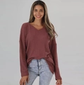Detail of V-neck long sleeve top showing the waffle knit texture and drop shoulder design - Brick Red