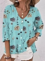 Close-up of teal floral V-neck shirt showing button details and textured fabric - S / Cyan