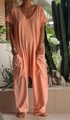 Detail of loose fit apricot V-neck jumpsuit featuring large side pockets and soft fabric - S / Orange