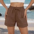 Detail of brown casual beach shorts featuring elastic waistband with drawstring and large pockets - Dark Brown