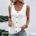 Close-up of white knitted tank top featuring eyelet pattern, buttons and shoulder ties - S / Tops / White