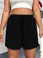 Detail of black drawstring waistband and fine knit texture on women's athletic shorts - Black