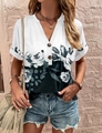 Detail of V-neckline with decorative buttons on a floral print short sleeve summer top - S / Black