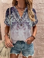 Close-up of bohemian paisley print on a V-neck blouse with wooden buttons texture - Pink