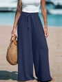 Dettaglio dei pantaloni a gamba larga a vita alta con elastico e fiocco sulla spiaggia - Blu navy