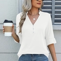Detail of white V-neck shirt showing elegant buttons and flowy ruffled sleeve cuffs - White