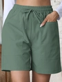 Women's high waist loose linen shorts in dark sage green with drawstring and large pockets - Sea Green