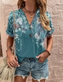 Detailed view of floral print blouse with V-neckline and vintage wooden buttons - Purple