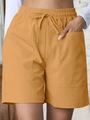 Women high waist loose linen shorts in ginger yellow with drawstring and pockets - Turmeric