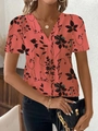 Dettaglio del top a maniche corte corallo con scollo a V e fantasia floreale nera - Taglia S / Top / Rosso