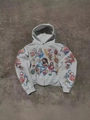 Detailed close-up of religious art prints on a grey zip-up hoodie with vintage tattoo patterns - Light Gray