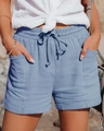 Detail of high-waisted fog blue gauze shorts featuring natural crinkle texture and drawstring - S / Bottoms / Light Blue