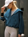 Detail view of dark teal quarter-zip cropped hoodie with drop shoulders in gym setting - S / Aqua