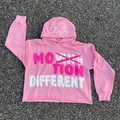 Detail of pink hoodie with foam print text and raw edge hem on asphalt background - S / Pink