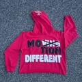 Detail of red cropped hoodie featuring streetwear graffiti letters and a raw hem finish - S / Red