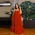 Detail of summer brick red maxi dress showing loose fit cut and ruffled hemline - Red