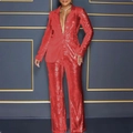 Detailed view of red sequin fabric texture on a long-sleeve blazer and wide-leg trousers - Red