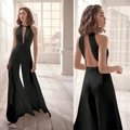 Elegante zwarte jumpsuit met V-hals, halter nek, wijde pijpen en borduurwerk - S / Zwart