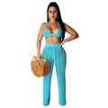 Detail of bright blue crochet halter top and hollow-out pants with woven bag - Lake Blue