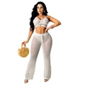 Detail of crochet knit two-piece set featuring tassel crop top and hollow out beach pants - White