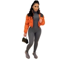 Detail of orange and black puffer jacket paired with a grey bodysuit and handbag - S / Black and Orange