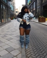 Chic knit cardigan with 3D blue flowers, denim shorts and matching denim thigh-high boots - White Background