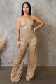 Detail view of khaki PU leather jumpsuit showing vertical metal button accents on wide legs - S / Khaki