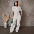 Detail view of a white short-sleeve jumpsuit with lapel collar and metal buttons - S / White