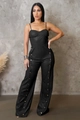 Detail of faux leather wide-leg jumpsuit with metallic gold buttons and thin straps - S / Black