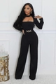 Detail of elegant black long sleeve jumpsuit featuring cutout neck and metal waist chain - S / Black