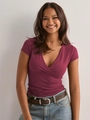 Detail of burgundy wrap-style deep V-neck slim fit T-shirt with soft fabric texture - S / Burgundy