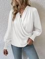 Close-up of elegant white wrap blouse featuring a deep V-neckline and smocked lantern sleeve - S / White