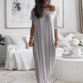 Detail view of a loose grey maxi dress with drop shoulders and functional side pockets - Gray