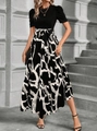 Detail of elegant black bodice and bubble sleeves with tied waist on floral print dress - Black & White