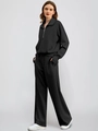 Detail of black two-piece sports tracksuit featuring half-zip collar and wide-leg trousers - S / Black