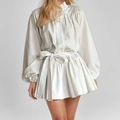 Detail of white long-sleeve mini dress with ruffles, lantern sleeves and waist bow tie - S / White